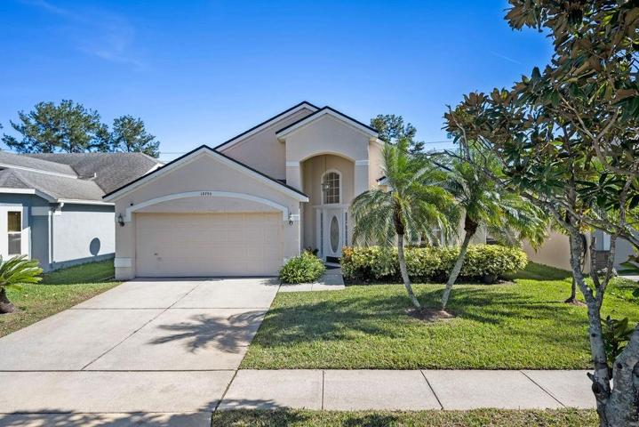 Lovely, freshly painted home showcasing 4 bedrooms, 2 bathrooms, a very large Florida room, and Florida front landscaping in the charming Waterford Lakes community.
