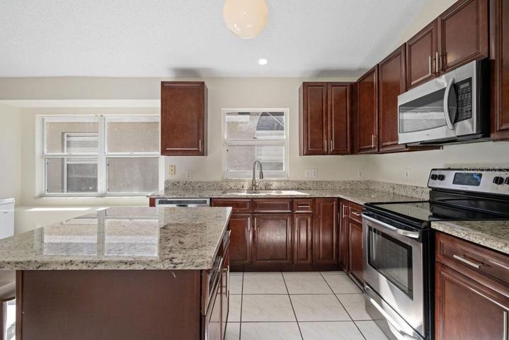 Kitchen features granite countertops, storage, and countertop eating.