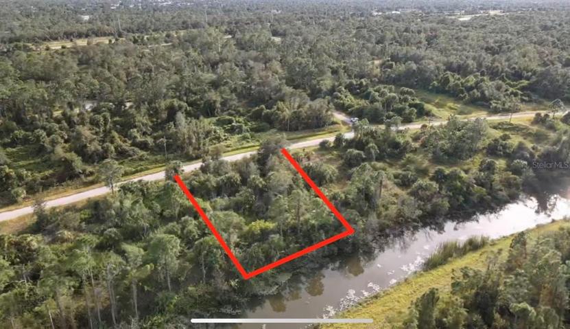 Back aerial view of property showing canal.