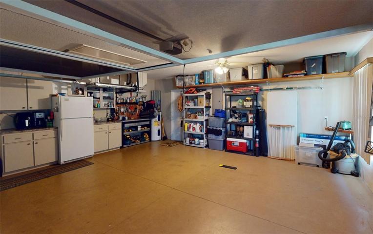 Garage with cabinets and shelves.