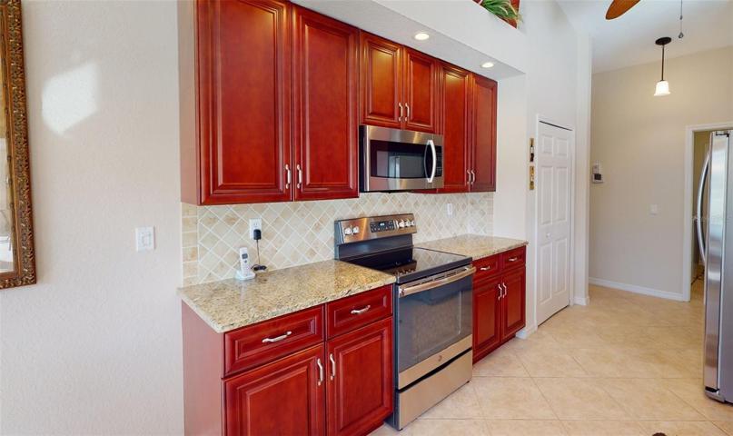 Kitchen counters and cabinets, other side.