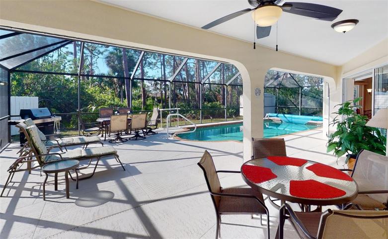 Looking at pool from covered lanai area.