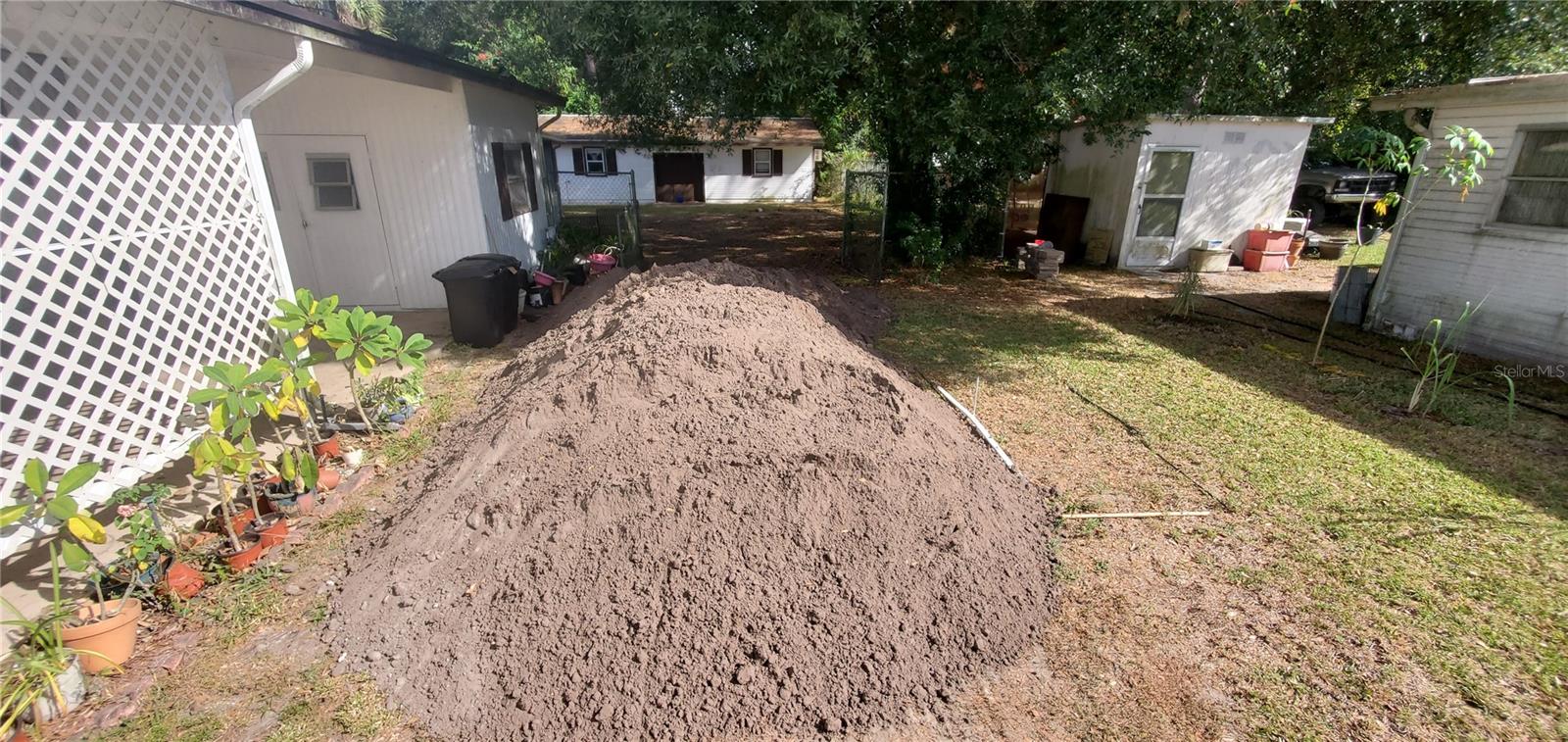 septic tank location on the right of the dirt piles