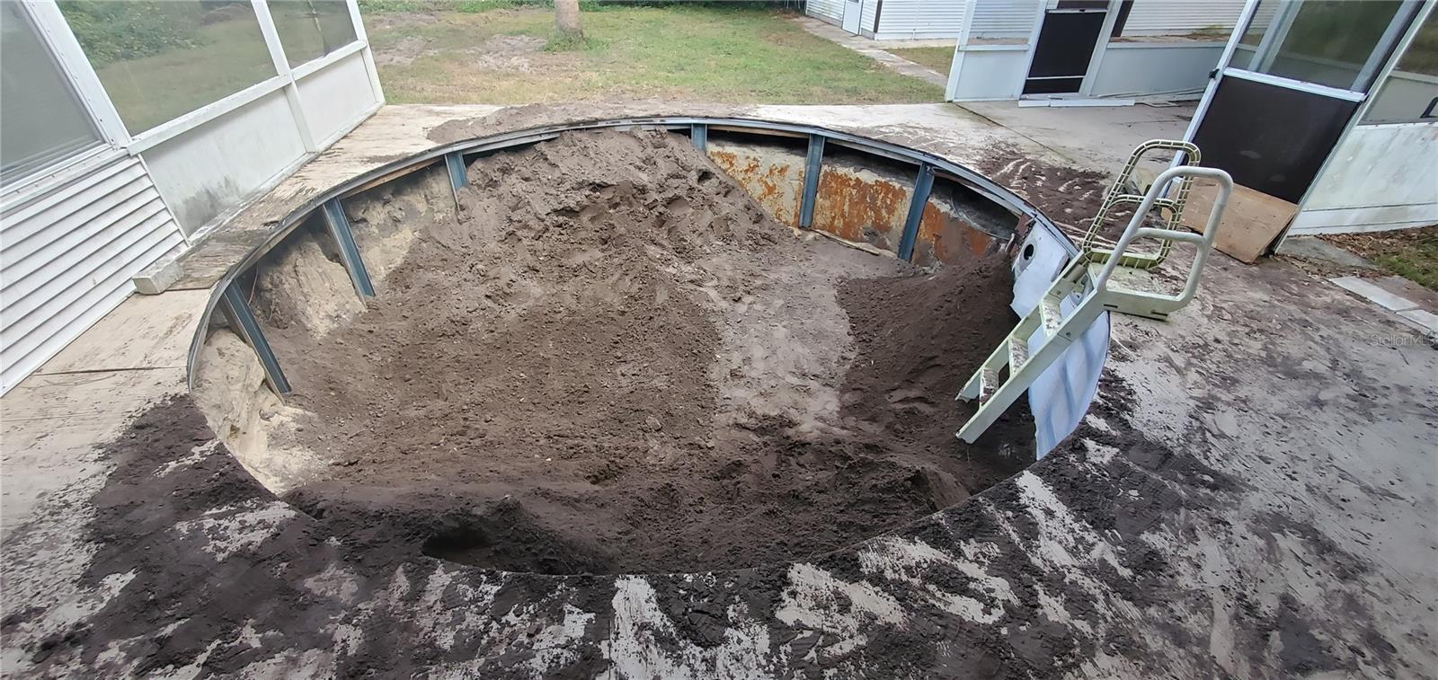 The pool is being filled in with dirt.