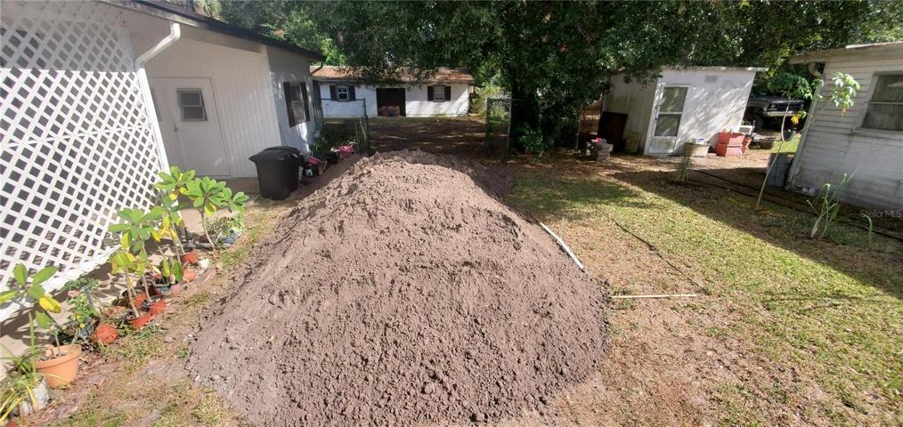 septic tank location on the right of the dirt piles