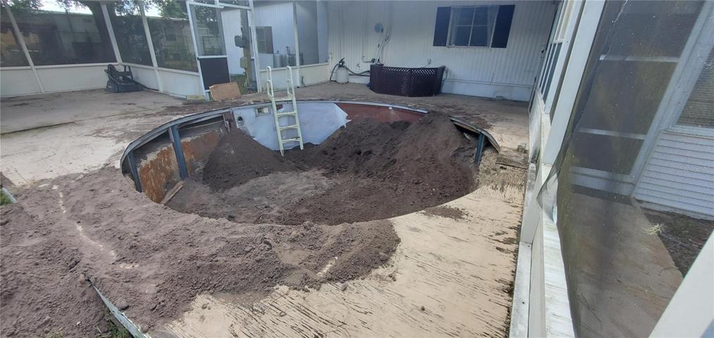 The pool is being filled in with dirt.