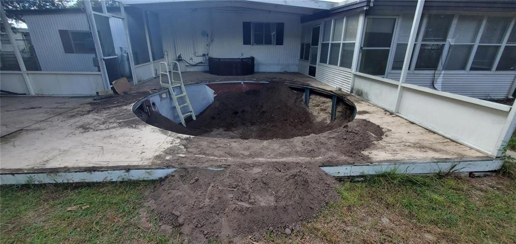 The pool is being filled in with dirt.