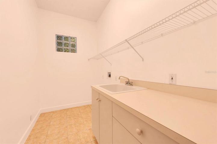 Inside utility room with washer/dryer hookups. Located next to garage area!