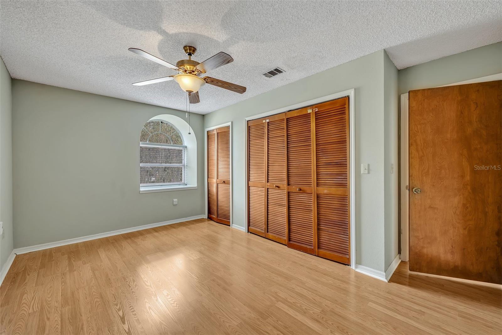 Bedroom facing front - wood flooring.