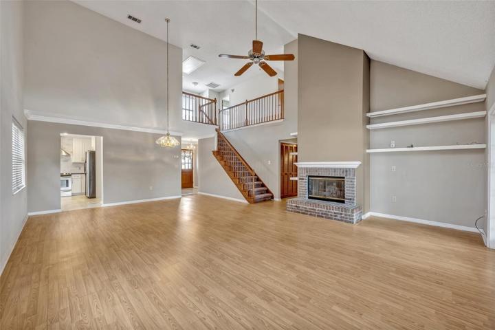 Great Room fireplace &amp; stairs to second floor.