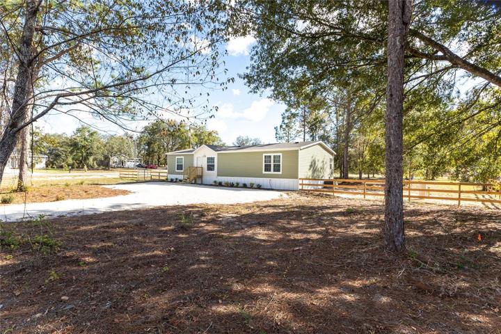 New home on a corner acre lot and paved road