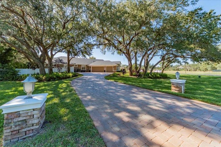 SECOND PAVERED DRIVEWAY AT SIDE OF PROPERTY LEADING TO THE SIDE ENTRY OVERSIZED 3 CAR GARAGE