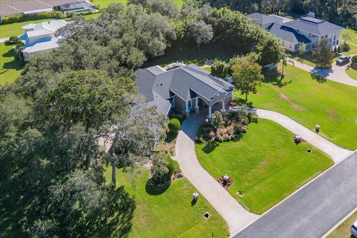 AERIAL VIEW SHOWING THE MAIN PAVERED CIRCULAR DRIVEWAY LEADING TO THE PORTICO AT THE FRONT ENTRY