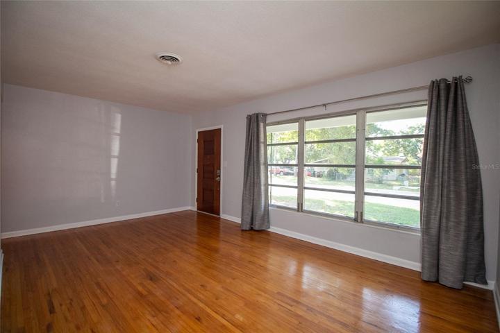 Living room with large windows and hardwood floors