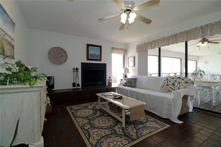 Family room with wood burning fireplace and triple slider to lanai