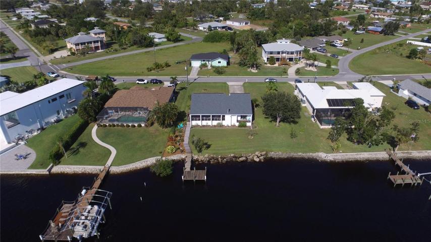 Home with riprap seawall and dock
