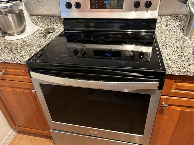 Full size range with five-burner cooktop.