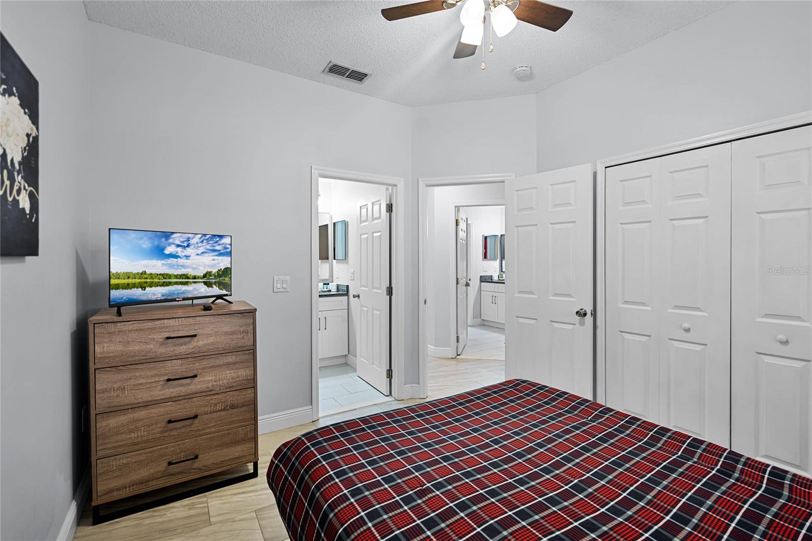 Bedroom 2 with queen bed and TV