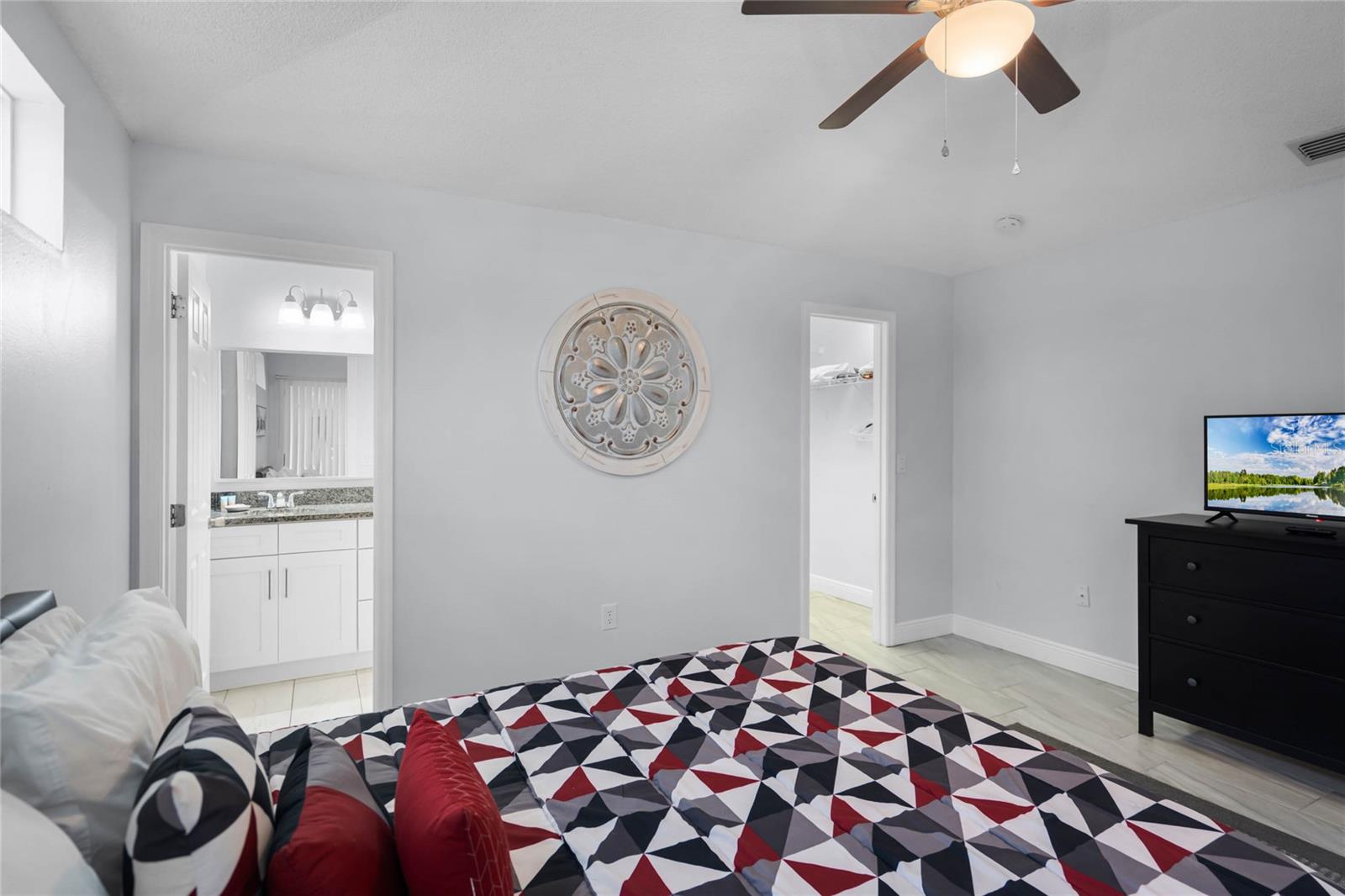 Master bedroom with queen bed and TV