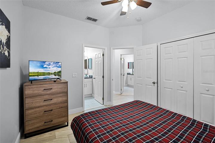 Bedroom 2 with queen bed and TV