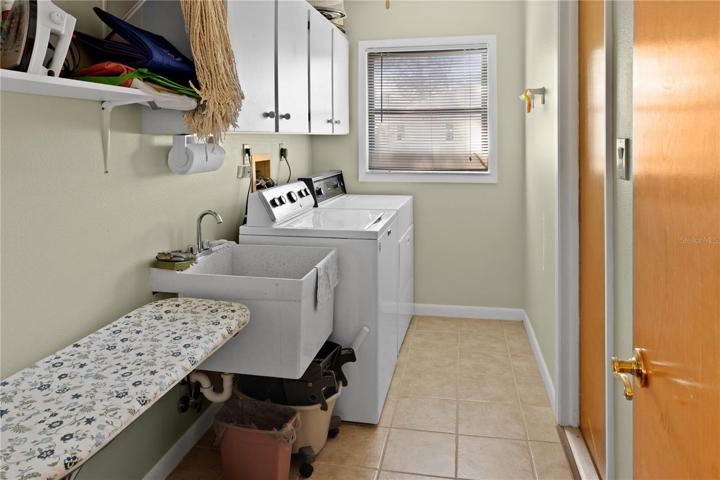 There is a laundry room with storage.