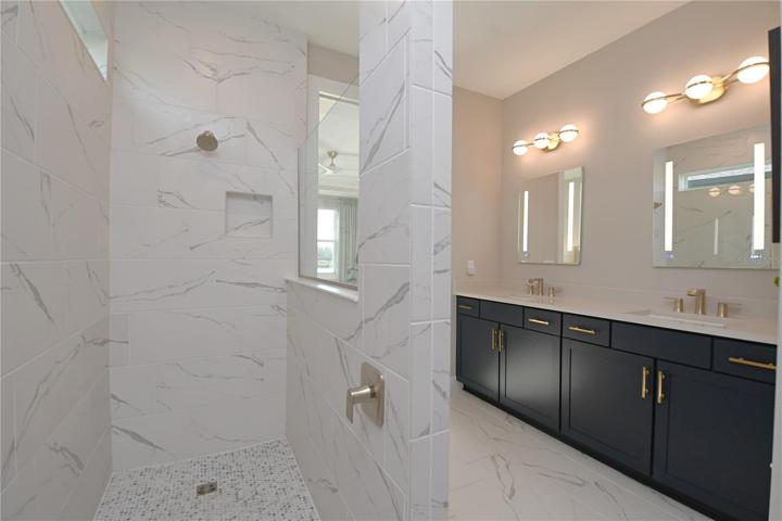 The primary features and oversized, tiled walk-in shower