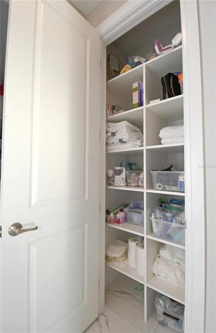 The primary bath features a built in linen closet.