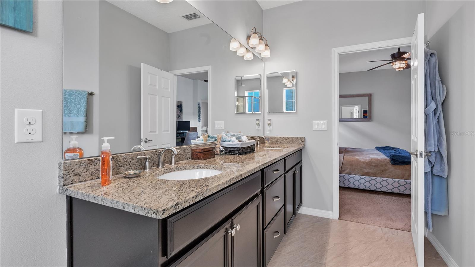 The private master suite features a large bedroom and includes a private ensuite bathroom with upgraded taller double vanities, soaking tub, and spacious walk-in shower, linen closet, and a separate toilet room.