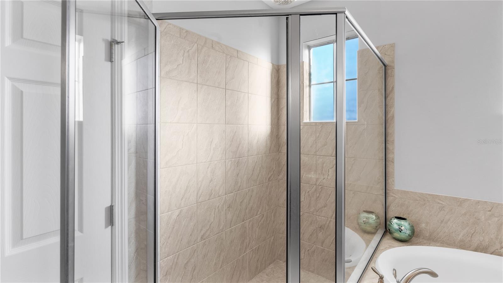 The private master suite features a large bedroom and includes a private ensuite bathroom with upgraded taller double vanities, soaking tub, and spacious walk-in shower, linen closet, and a separate toilet room.