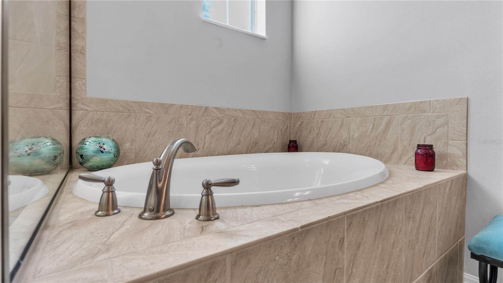 The private master suite features a large bedroom and includes a private ensuite bathroom with upgraded taller double vanities, soaking tub, and spacious walk-in shower, linen closet, and a separate toilet room.