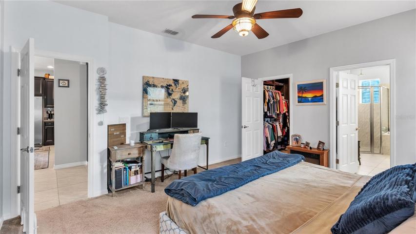 The private master suite features a large bedroom and includes a private ensuite bathroom with upgraded taller double vanities, soaking tub, and spacious walk-in shower, linen closet, and a separate toilet room.