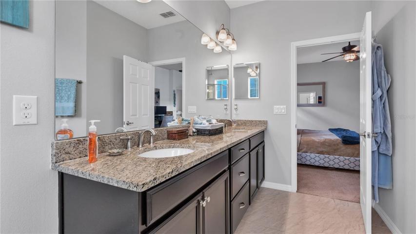 The private master suite features a large bedroom and includes a private ensuite bathroom with upgraded taller double vanities, soaking tub, and spacious walk-in shower, linen closet, and a separate toilet room.