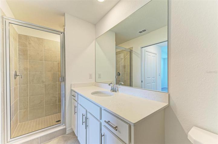 Master bathroom with upgraded vanity and tiled shower