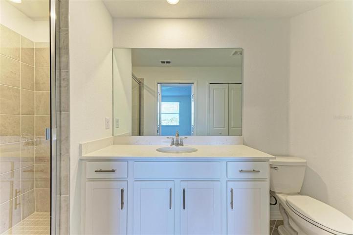 Master bathroom with upgraded vanity and tiled shower