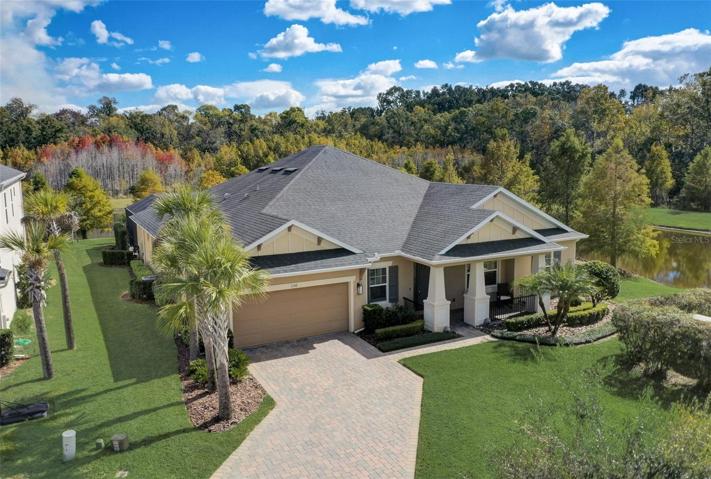 Perfect location in gated community of the Retreat at Lake Charm in Oviedo with water and wooded views
