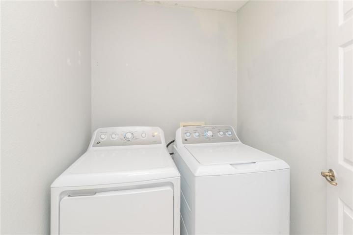 Indoor laundry room with new washer and dryer