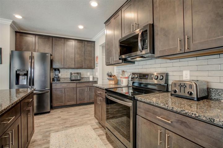 Kitchen has Ample Storage and Til Backsplashes