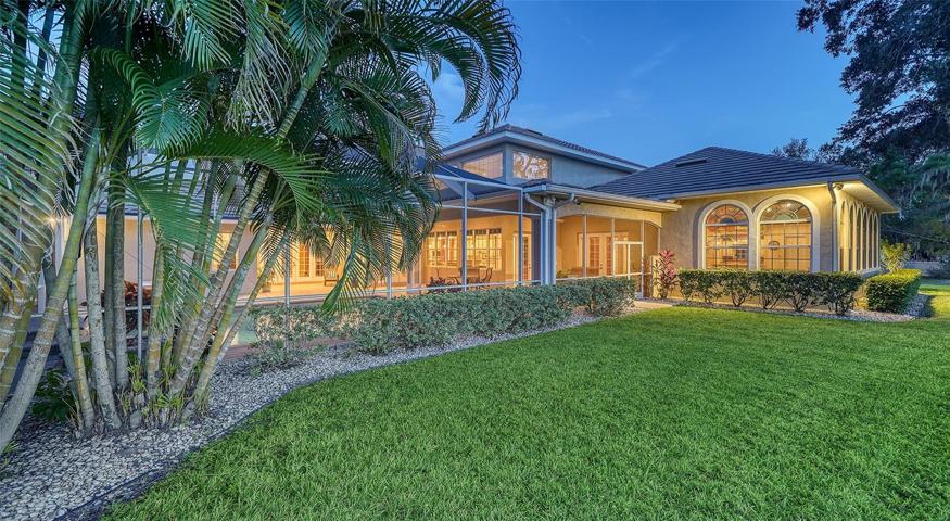 The estate is surrounded by beautiful natural landscaping.