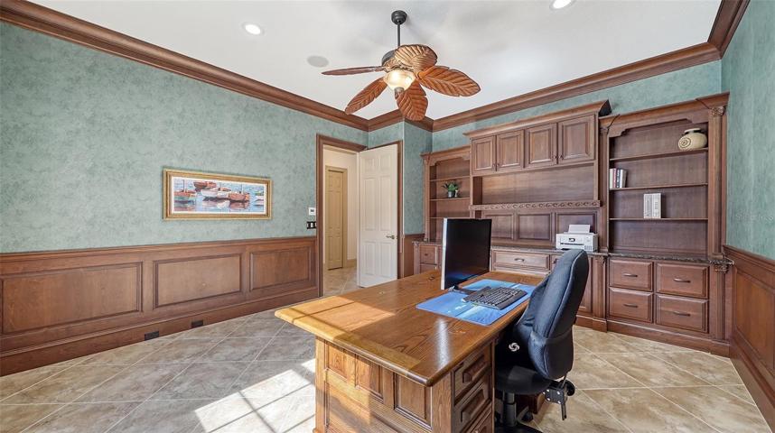 The well-appointed office with maple built-ins and crown moldings.