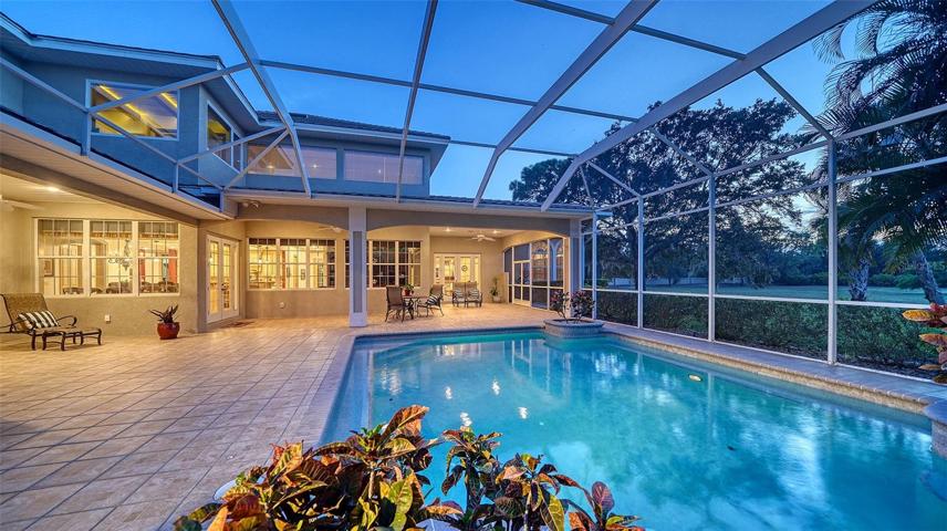 The private screened lanai bestows serenity with broad vistas of the grounds.