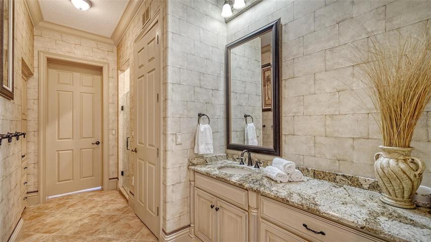 A full bathroom, with dual access from the rec room and across from the office.