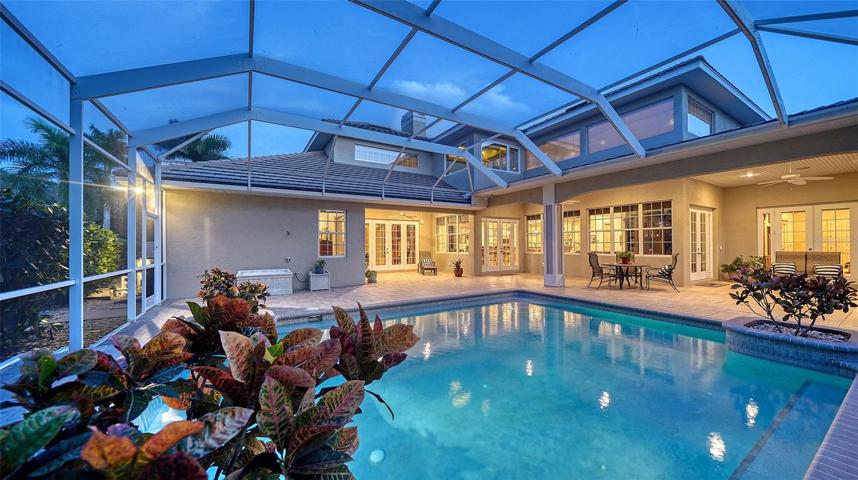 The private screened lanai bestows serenity with broad vistas of the grounds.