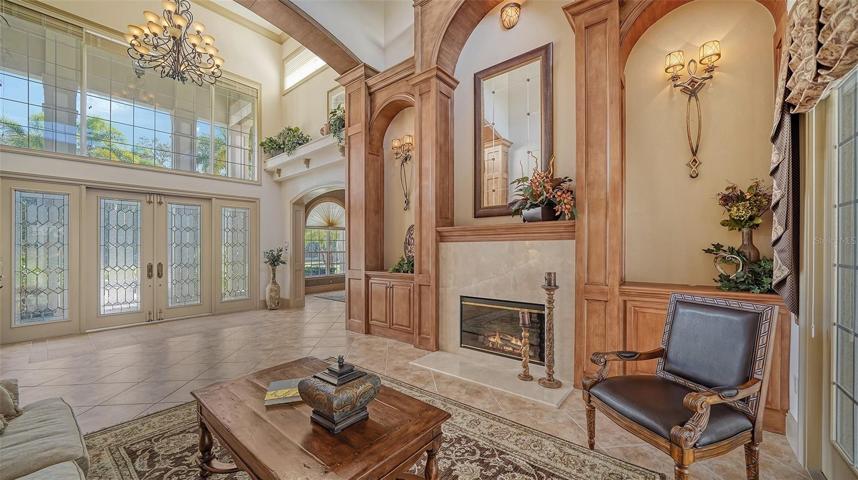 The drama begins as you enter the foyer with soaring 23' ceiling and adjacent inviting living room.