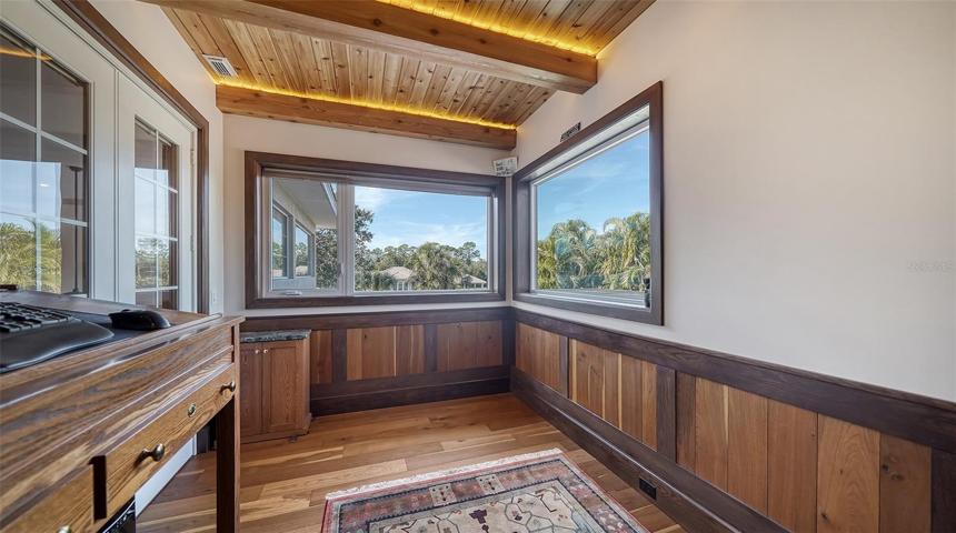 Upper level private office with wood beamed ceiling.