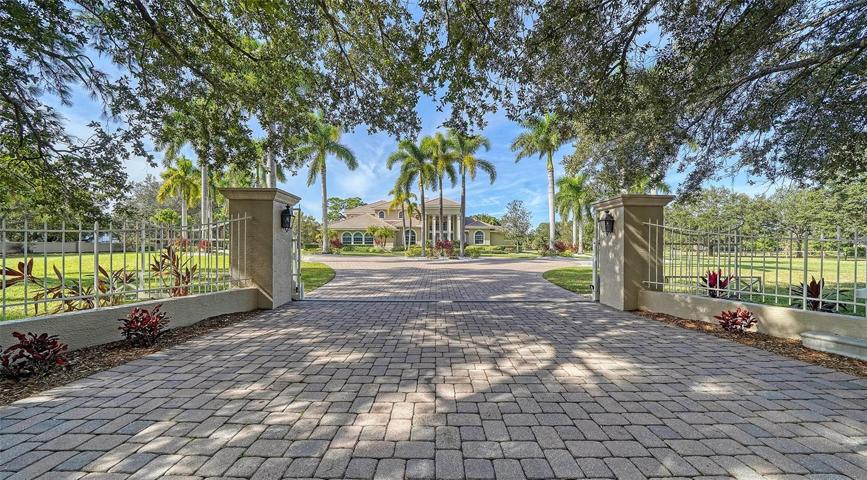 Enter through your private gate into the  tranquil 5+ acre park-like setting.