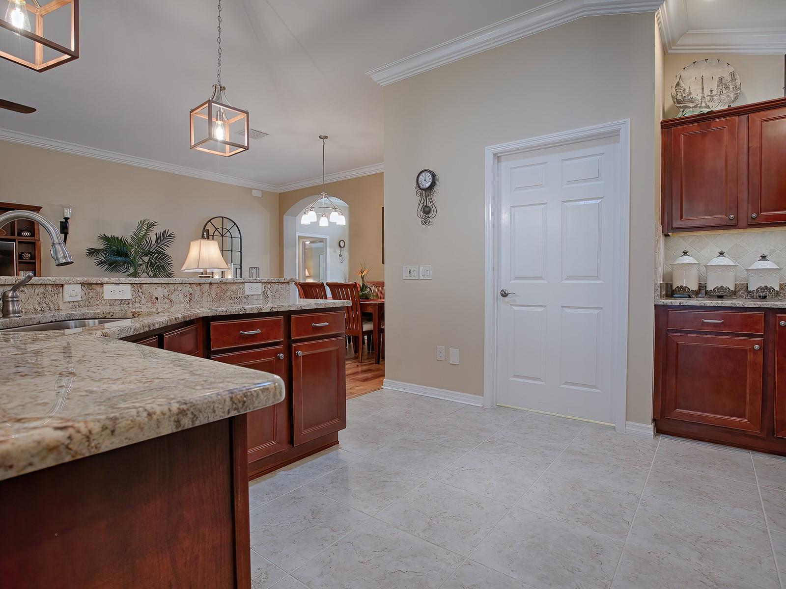 DOOR IN BACKGROUND LEADS TO YOUR LAUNDRY ROOM AND OUT TO THE GARAGE.