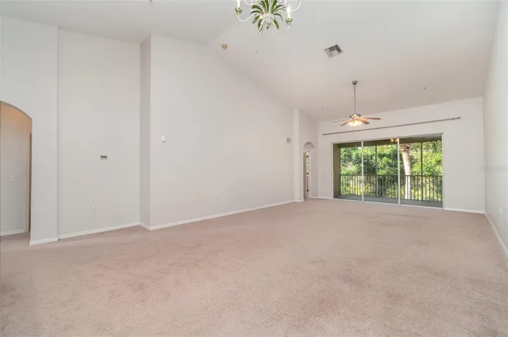 A generously sized living room, complete with a dining area, offers views of the preserve through vast sliding glass doors that lead to the private balcony.