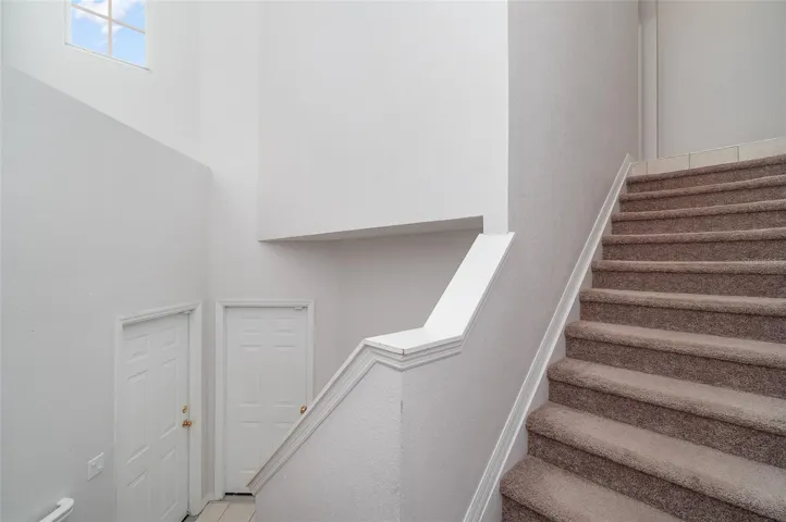 Stair view- garage door is to the right and entry door is to the left.