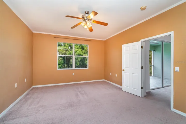Primary bedroom, spacious enough to accommodate a king-sized bed, offers views of the private preserve.