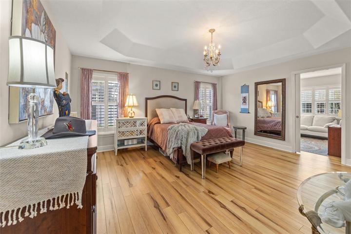 PRIMARY BEDROOM WITH VINYL PLANK FLOORING